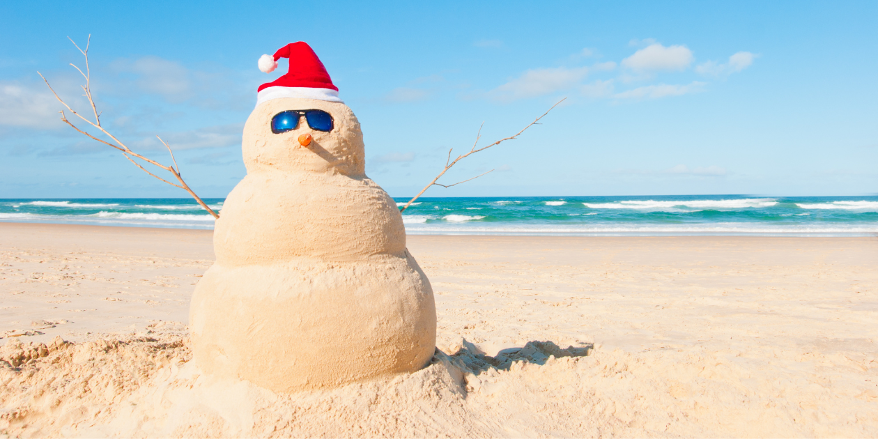 snowman at the beach celebrating Christmas in July
