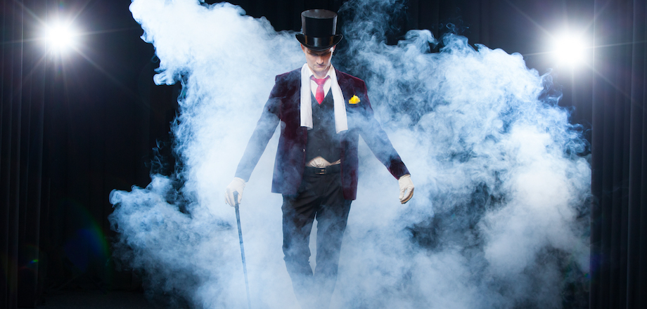 Magician appearing through a cloud of smoke