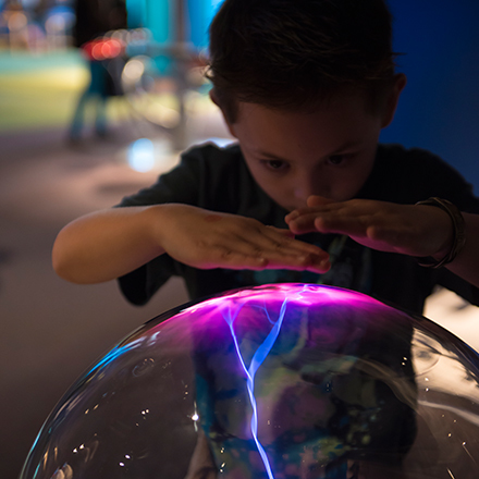 Child playing at a science exhibit