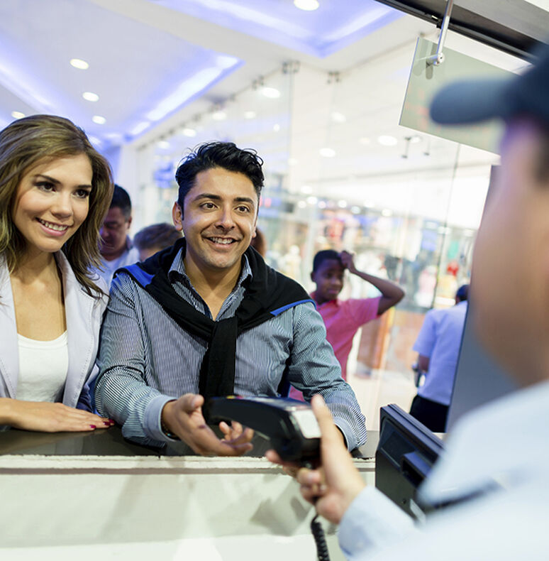 Couple purchasing tickets at a box office