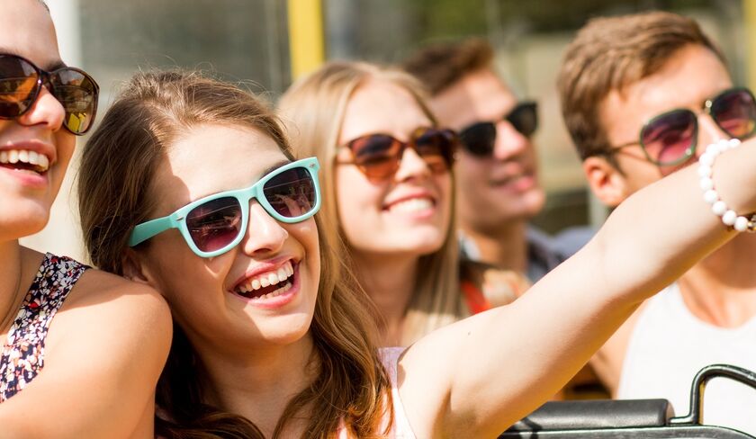 Group of young adults smiling with sunglasses